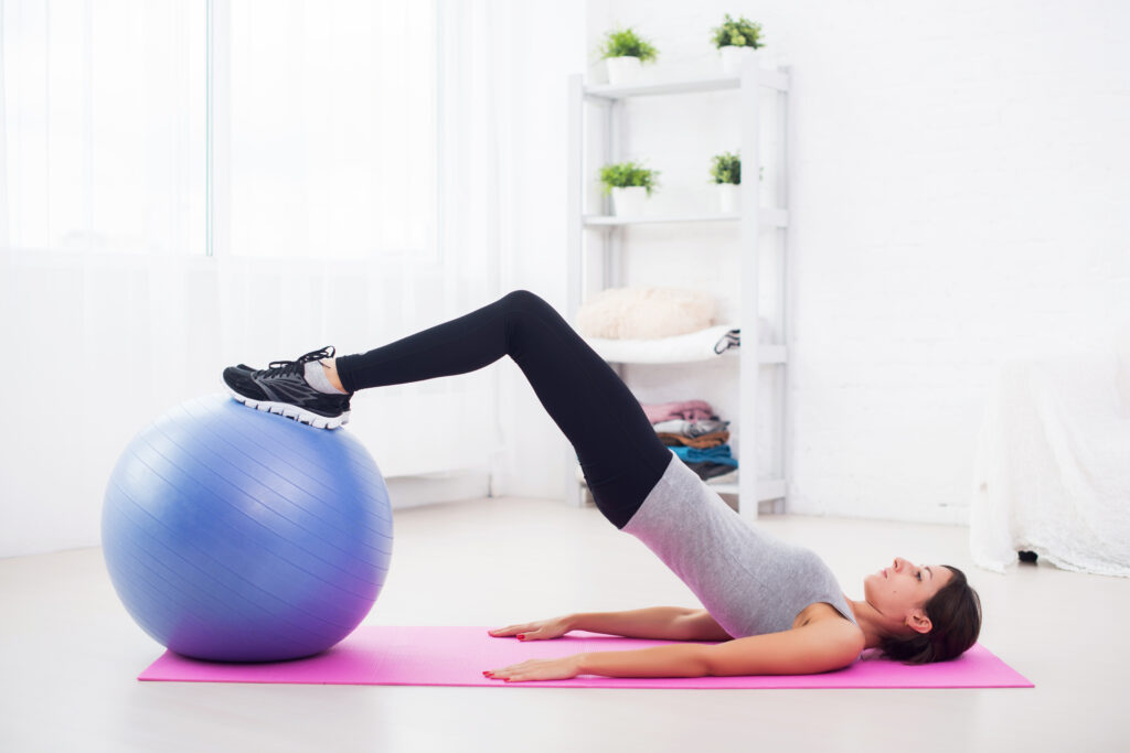 woman doing pelvic floor exercises with medicine ball. Get a physiotherapist in Valencia, Spain with Valencia Physio